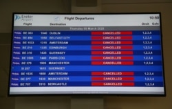 An electronic flight departure board displays 'cancelled' statuses for all Flybe flights at Exeter Airport in Exeter, England, March 5, 2020, following news that the airline had collapsed into bankruptcy.