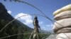 An Indian paramilitary soldier stands guard at a check post along a highway leading to Ladakh, at Gagangeer, some 81 kilometers from Srinagar, the summer capital of Indian Kashmir, on June 17, 2020. 