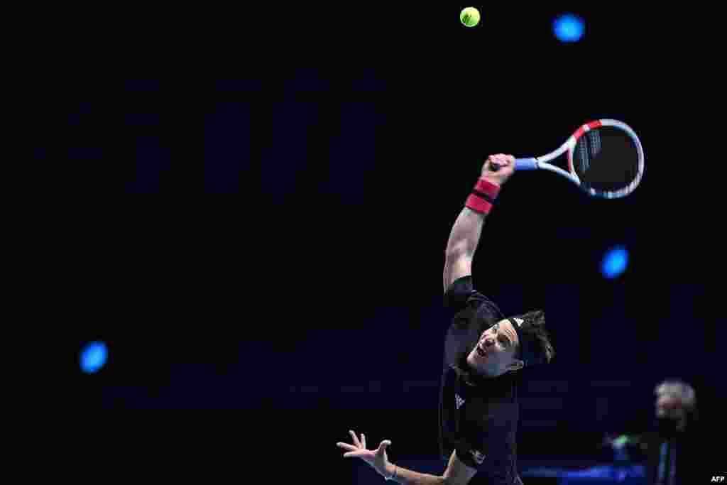 Austria's Dominic Thiem serves against Greece's Stefanos Tsitsipas in their men's singles round-robin match on day one of the ATP World Tour Finals tennis tournament at the O2 Arena in London.