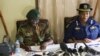 Zimbabwe army spokesperson Colonel Overson Mugwisi, left, addresses a press conference with police spokeswoman Charity Charamba, at Police General Headquarters in Harare, Zimbabwe, Nov. 27, 2017.