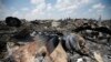 Ukraine -- People walk near the wreckage of Malaysia Airlines MH17, that was shot down near Hrabove, in the Donetsk region, on July 23, 2014.