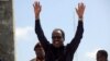 Somalia's President Hassan Sheikh Mohamud waves to the guests as he arrives for Independence Day celebrations outside the ruins of the former parliament buildings in Somalia's capital, Mogadishu, July 1, 2016.