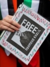 A demonstrator holds a sign during a protest at the University of California Los Angeles (UCLA), following the arrest in New York by U.S. immigration agents of Palestinian student protester Mahmoud Khalil, in Los Angeles, California, March 11, 2025.