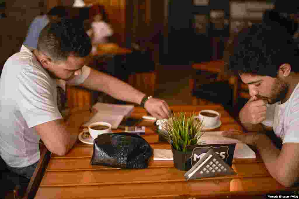 A respite from the heat. Students find refuge in Alexandria’s upscale coffee houses where air conditioning is turned on full blast.
