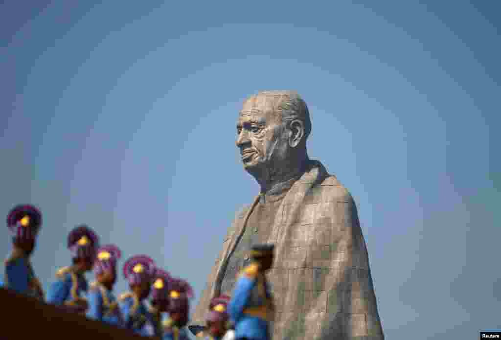 Police officers stand near the "Statue of Unity" portraying Sardar Vallabhbhai Patel, one of the founding fathers of India, during its inauguration in Kevadia, in the western state of Gujarat.