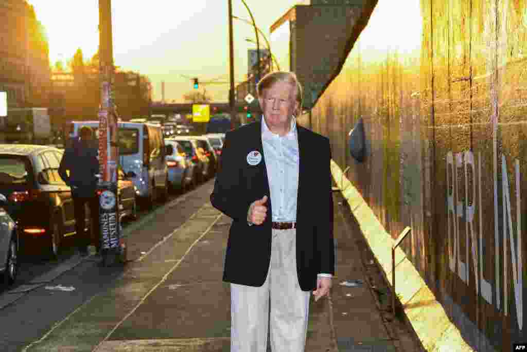 Madame Tussauds museum's wax figure of U.S. President is displayed along the East Side Gallery section of the Wall in Berlin, Germany.