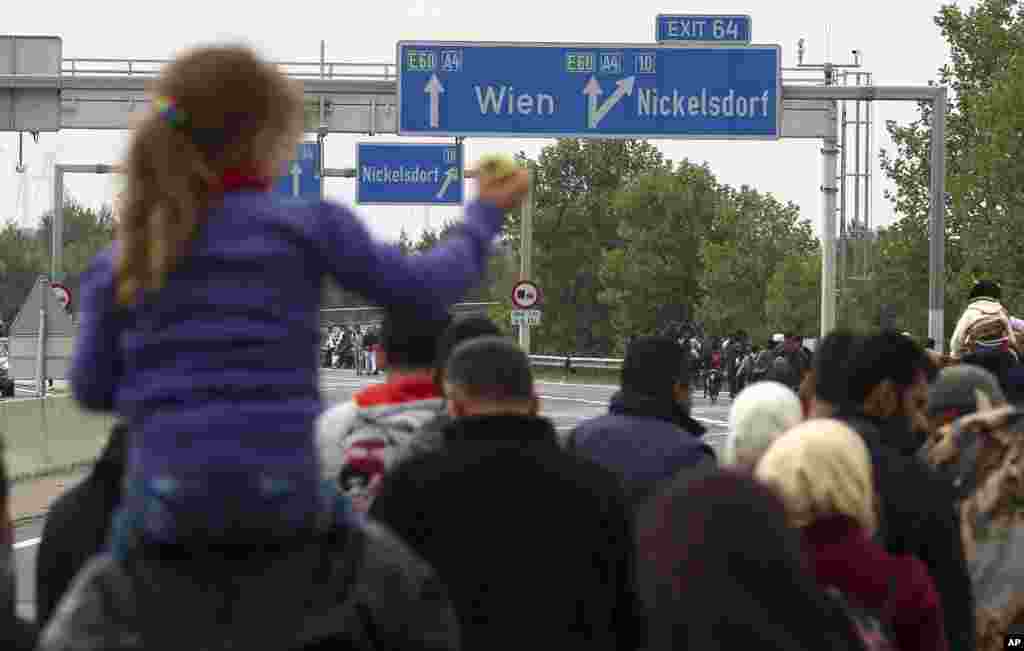 Migrants walk on the highway A4 toward Vienna after crossing the Hungarian-Austrian border near Nickelsdorf, Austria.