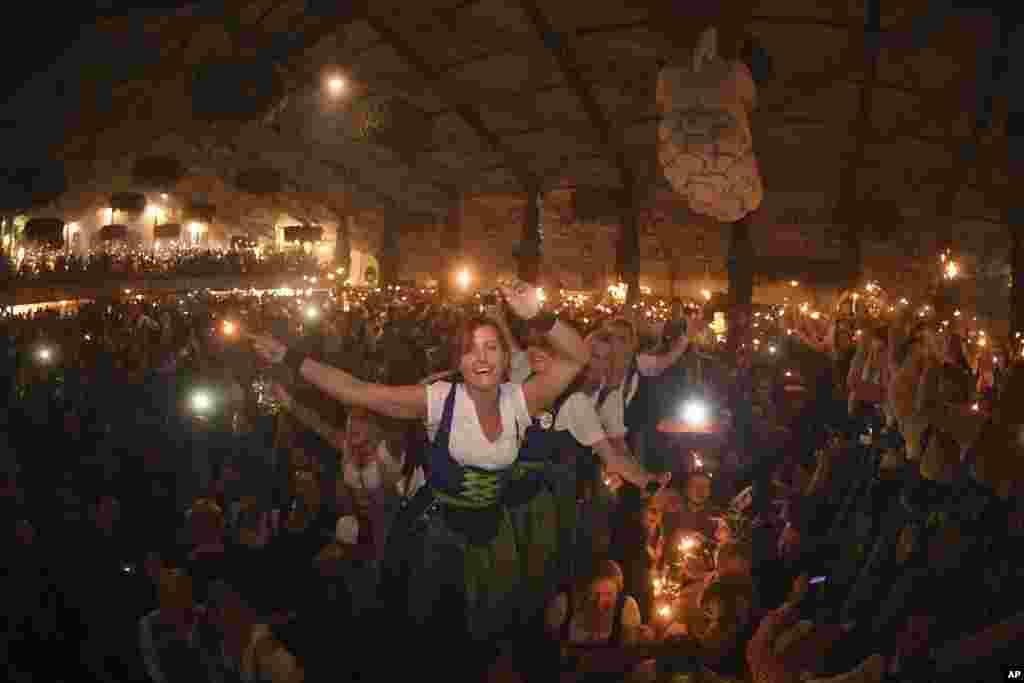 Waitresses celebrate after closing of a tent on the last day of the Oktoberfest beer festival in Munich, southern Germany, Oct. 3, 2017.