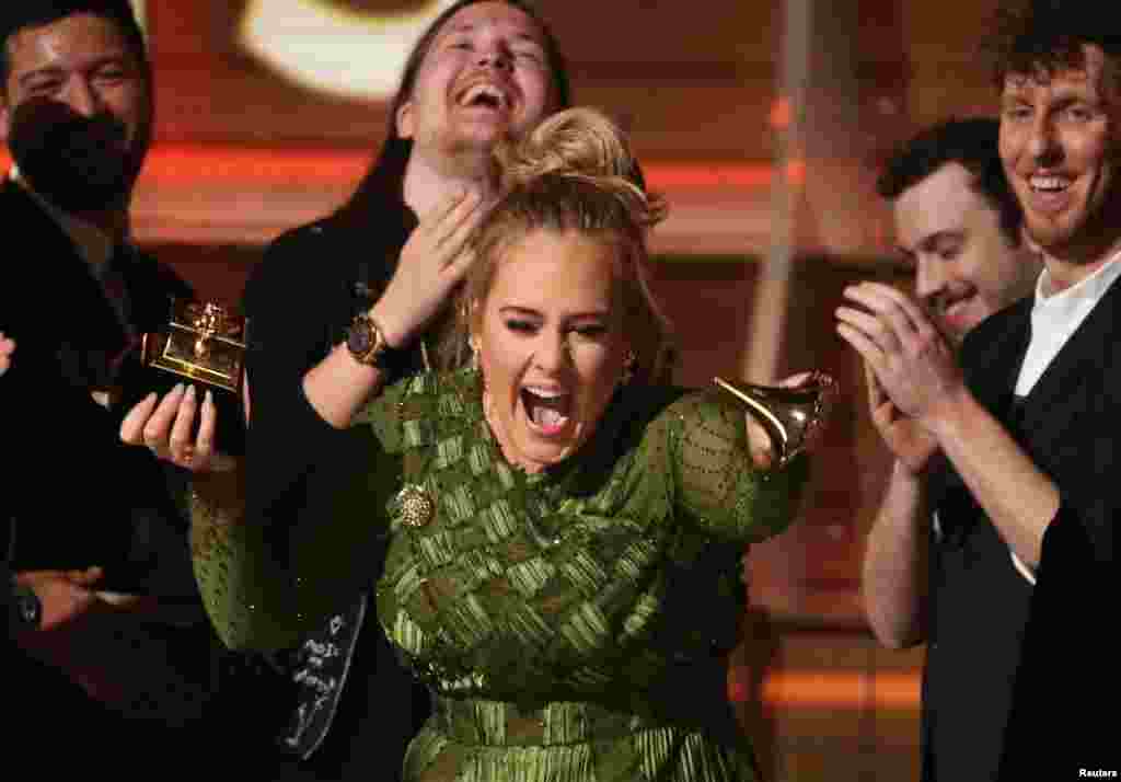 Adele breaks the Grammy for Record of the Year for "Hello" after having it presented to her at the 59th Annual Grammy Awards in Los Angeles, California, Feb. 12, 2017.