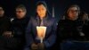 A woman holds a candle as Cardinal Robert Francis Prevost, Prefect of the Dicastery for Bishops, leads the recitation of the Holy Rosary for Pope Francis' health in St Peter's Square at the Vatican, March 3, 2025. 