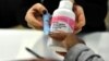 FILE - A mother gets an antiretroviral drug at the Chris Hani Baragwanath Hospital, South Africa's largest public hospital, in Soweto.
