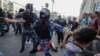 Russia -- Riot police use batons during an opposition rally in Moscow on July 27, 2019. Thousands of people took to the streets to protest the banning of opposition candidates from municipal elections set for September 8. 