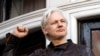 FILE - In this May 19, 2017 photo, WikiLeaks founder Julian Assange greets supporters outside the Ecuadorian embassy in London, where he has been in self imposed exile since 2012. 