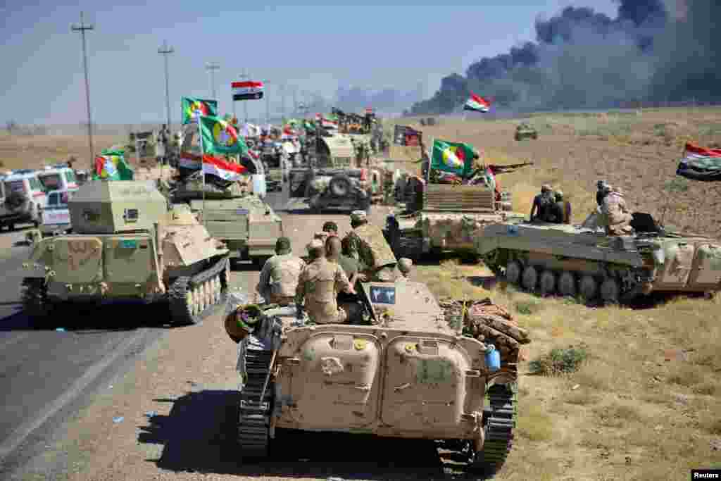 Shi'ite Popular Mobilization Forces (PMF) and Iraqi army members gather on the outskirts of Hawija.