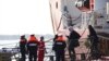 People disembark from the Ocean Viking rescue ship, at the Taranto harbor, Southern Italy, Jan. 29, 2020.