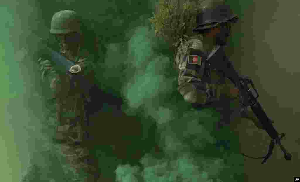 Afghan National Amy commandos take their position near a building during a military exercise in Kabul.